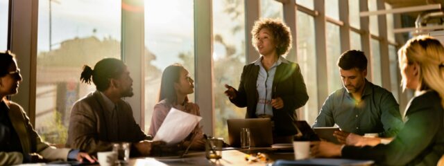 woman-in-office-presenting-to-colleagues